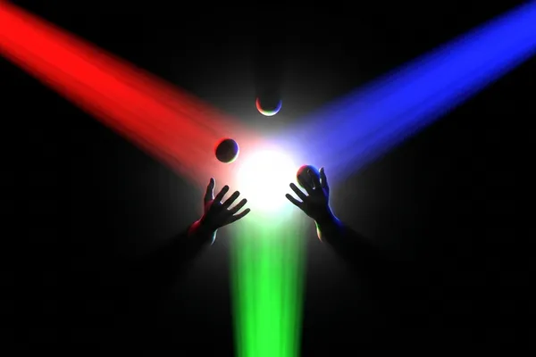 Hands juggling with colorful RGB light trails