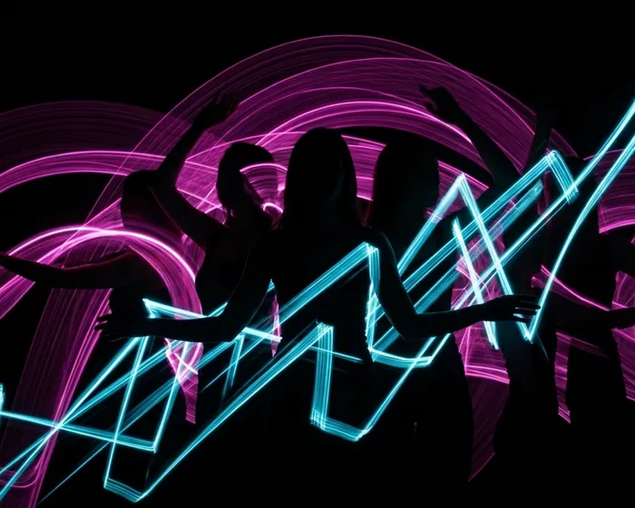 Multiple silhouettes with overlapping light trails showing chaos and saturation of motion